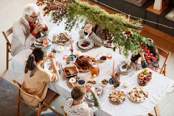 Family Prays Before Thanksgiving Dinner